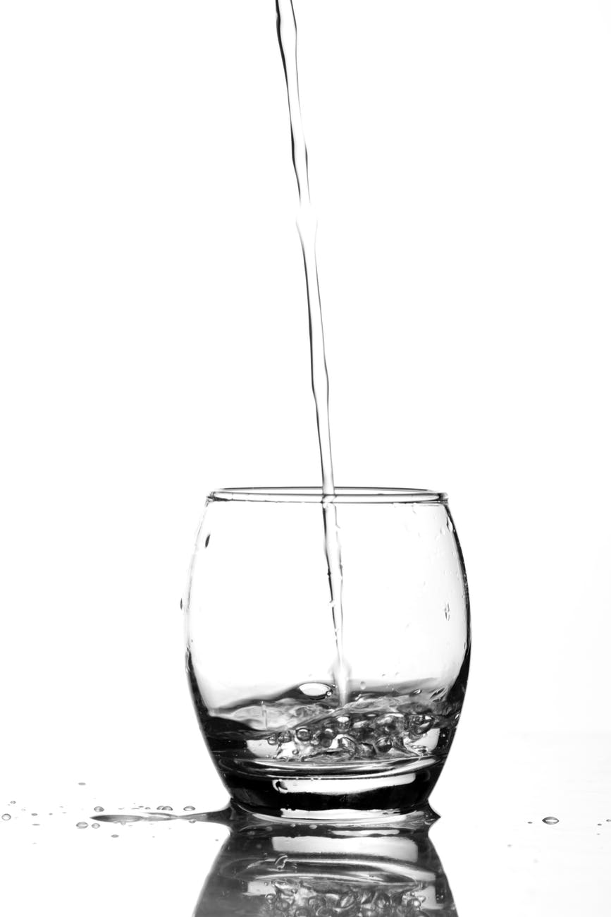close up of water splashing in glass