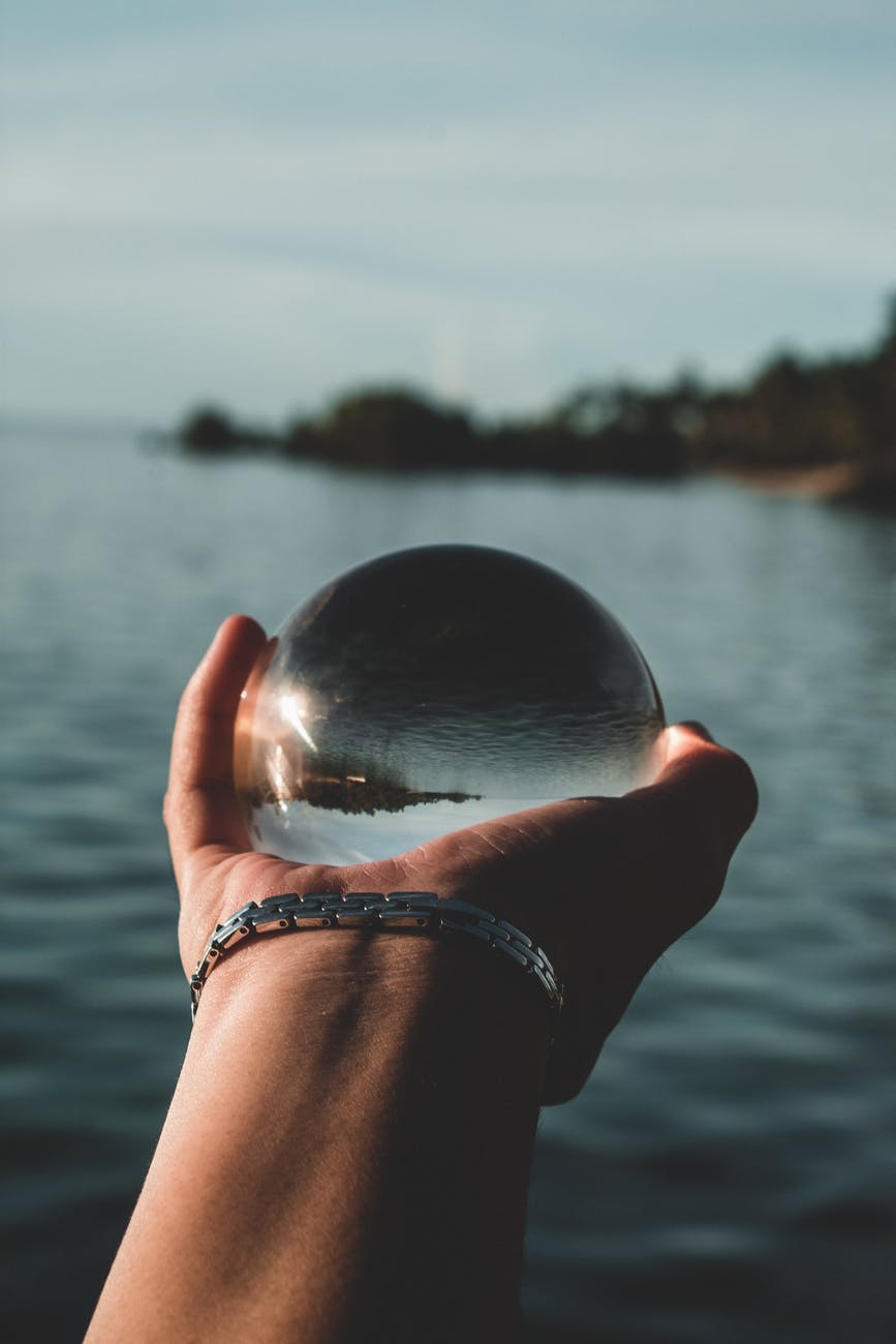 person holding glass ball