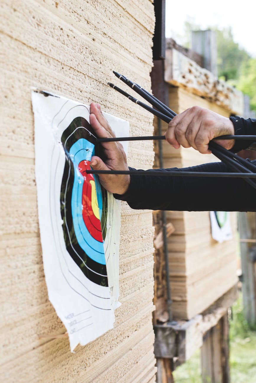 photo of person taking out arrows from target board