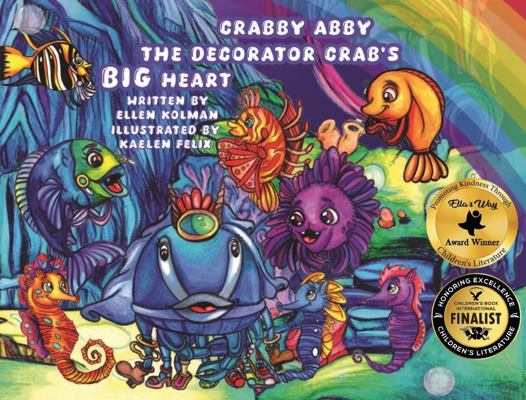 Colorful book cover featuring cartoon sea creatures including a crab, fish, and seahorse. The title reads 'Crabby Abby The Decorator Crab's BIG Heart' with awards for children's literature visible in the corner.